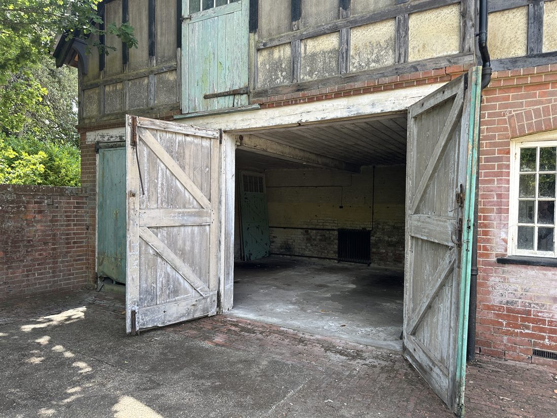 Coach house garage bay with timber doors